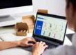 Laptop with e-commerce dashboard and plain shipping boxes for zero inventory adult toy dropshipping