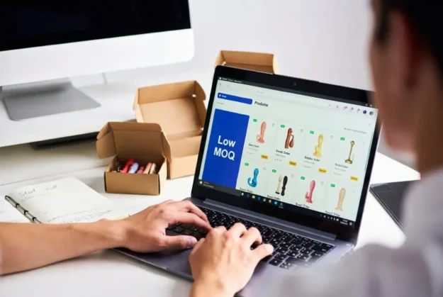 GQcJl Laptop with e-commerce dashboard and plain shipping boxes for zero inventory adult toy dropshipping