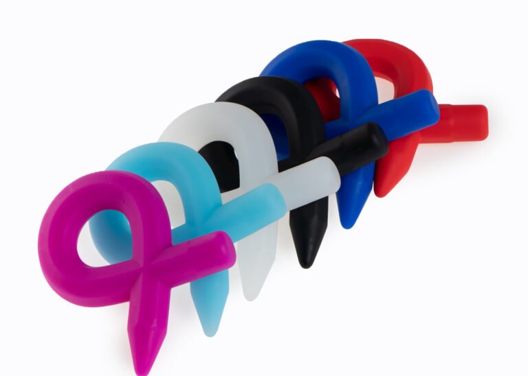 Colorful silicone cock rings with a pointed pencil-tip design, shown in pink, blue, white, black, and red