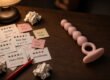 One-star sex toy reviews and complaint notes beside a finished silicone anal beads prototype