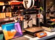 Startup desk with 3D model on tablet and desktop 3D printers making a low-cost product prototype